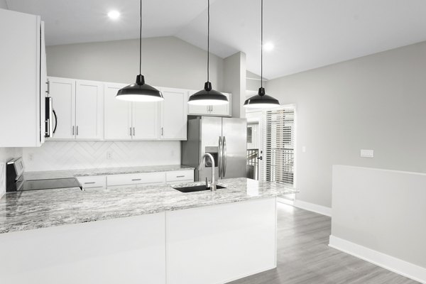 Modern kitchen featuring stainless steel appliances and granite countertops at Allora 168 Apartments