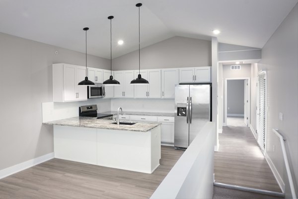 Modern kitchen with stainless steel appliances in Allora 168 Apartments