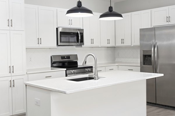 Modern kitchen with stainless steel appliances and granite countertops at Allora 168 Apartments