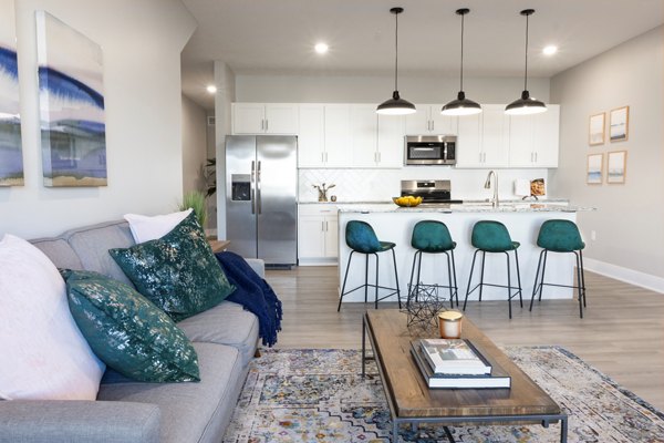 Spacious living room with modern furnishings and natural lighting at Allora 168 Apartments