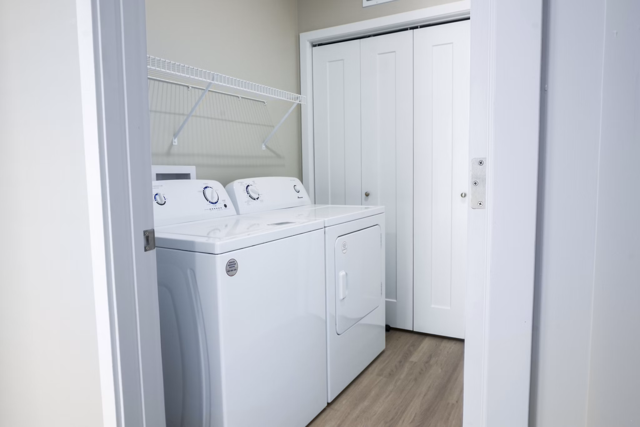 Laundry room with modern appliances at Allora 168 Apartments