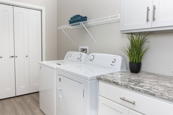 Laundry room with modern appliances at Allora 168 Apartments