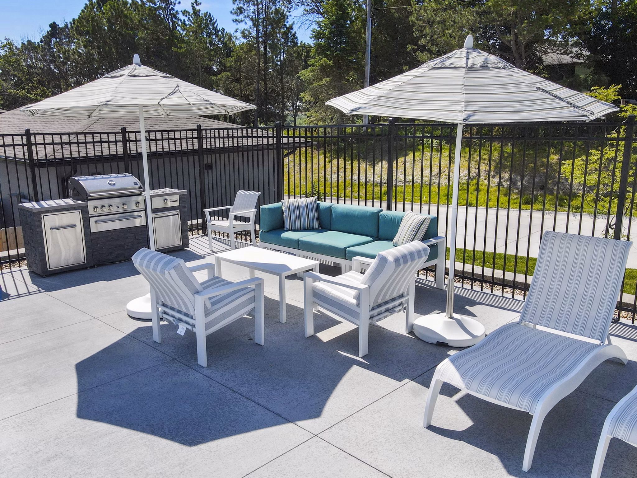 Outdoor grill area/patio at Allora 168 Apartments, perfect for entertaining and relaxation in a luxurious setting