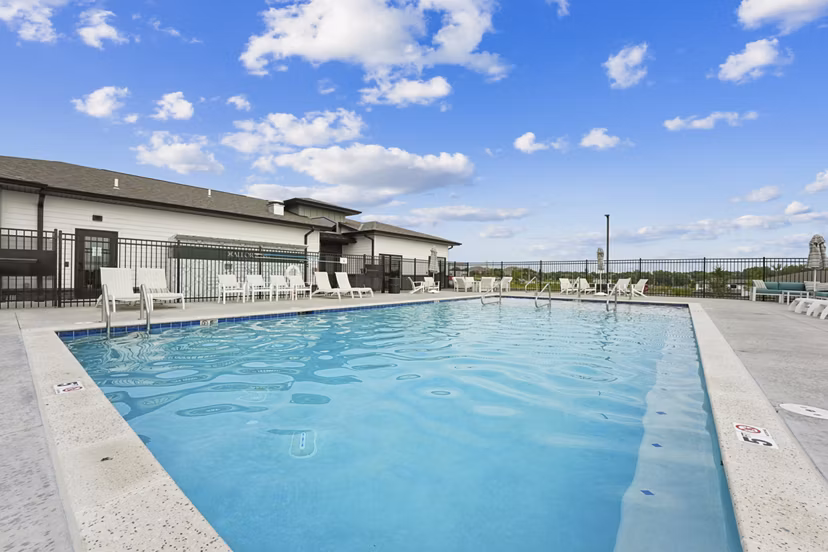 Luxurious poolside escape at Allora 168 Apartments with modern furniture and lush landscaping