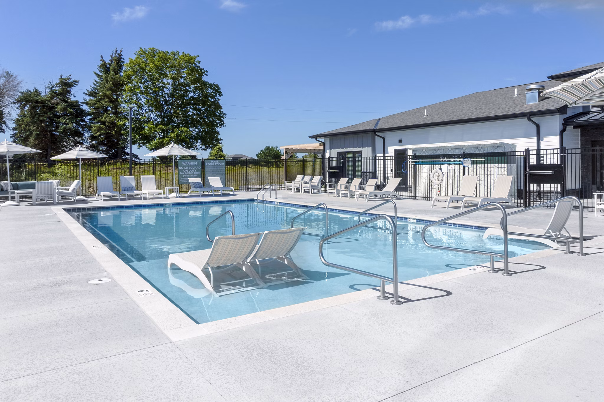 Luxurious poolside escape at Allora 168 Apartments with modern furniture and lush landscaping