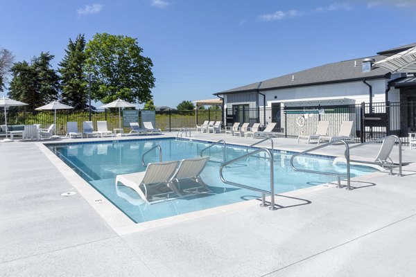 Luxurious poolside escape at Allora 168 Apartments with modern furniture and lush landscaping
