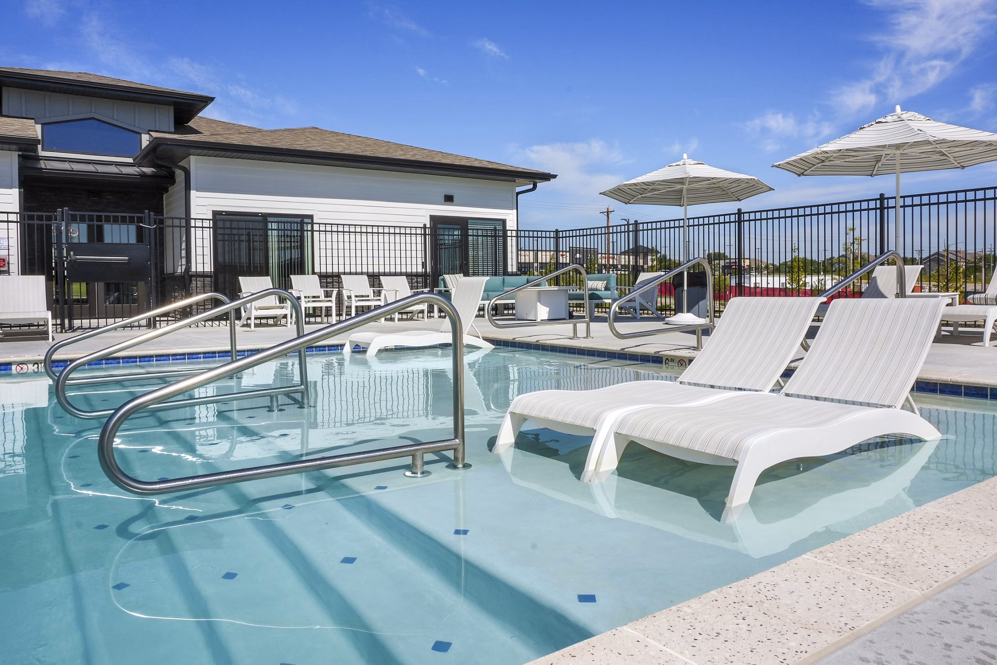 Luxurious poolside with sun loungers at Allora 168 Apartments