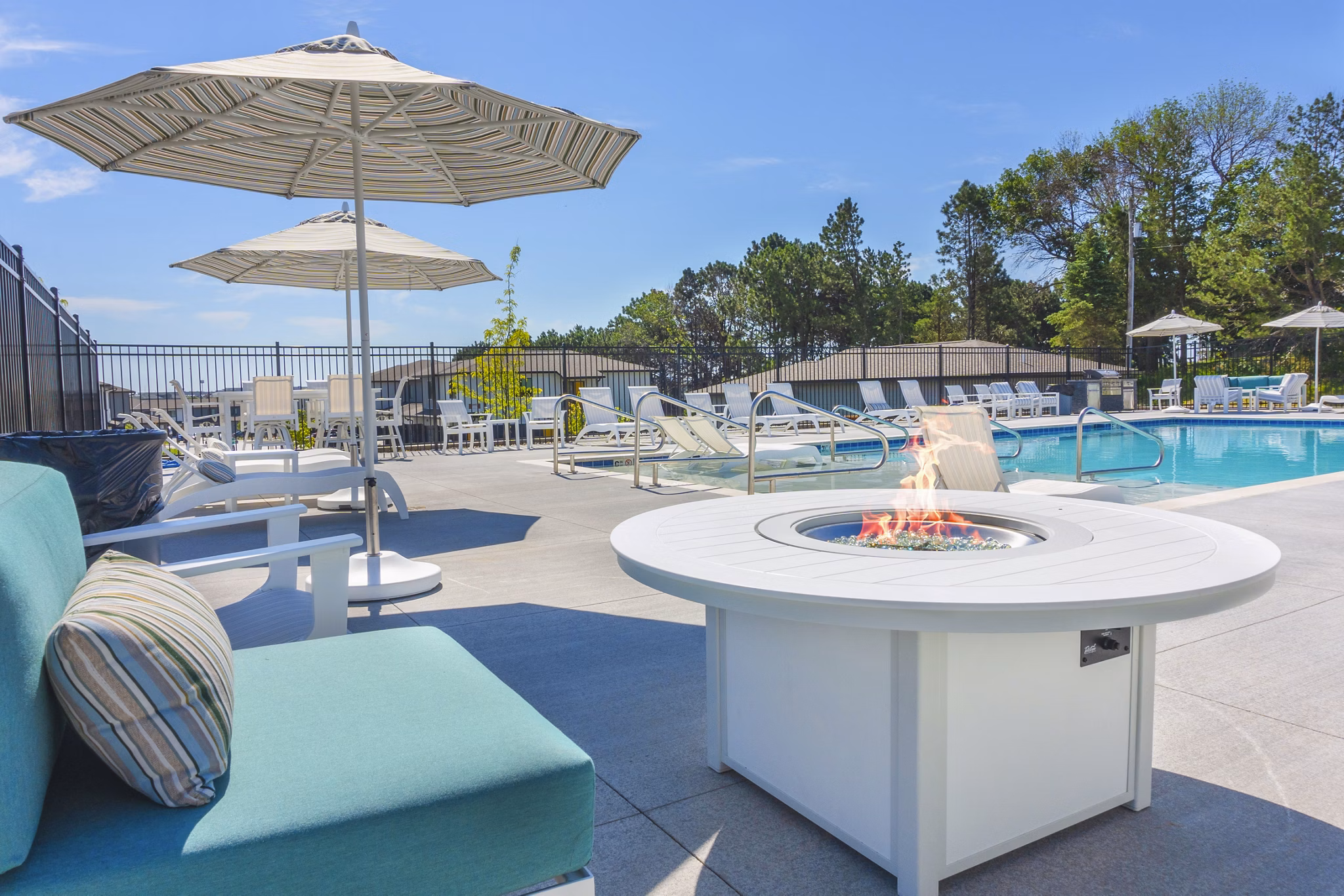 Cozy fire pit and pool area at Allora 168 Apartments, perfect for relaxing evenings in style