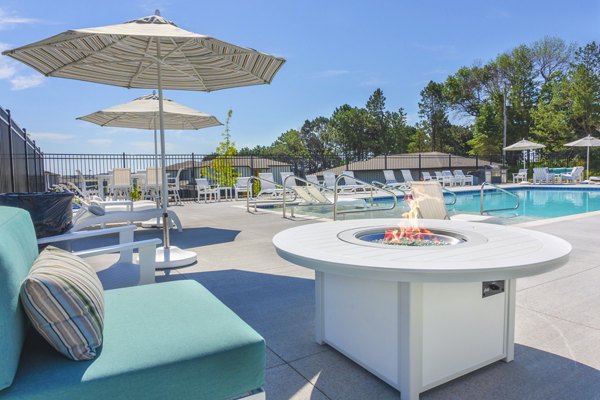 Cozy fire pit and pool area at Allora 168 Apartments, perfect for relaxing evenings in style