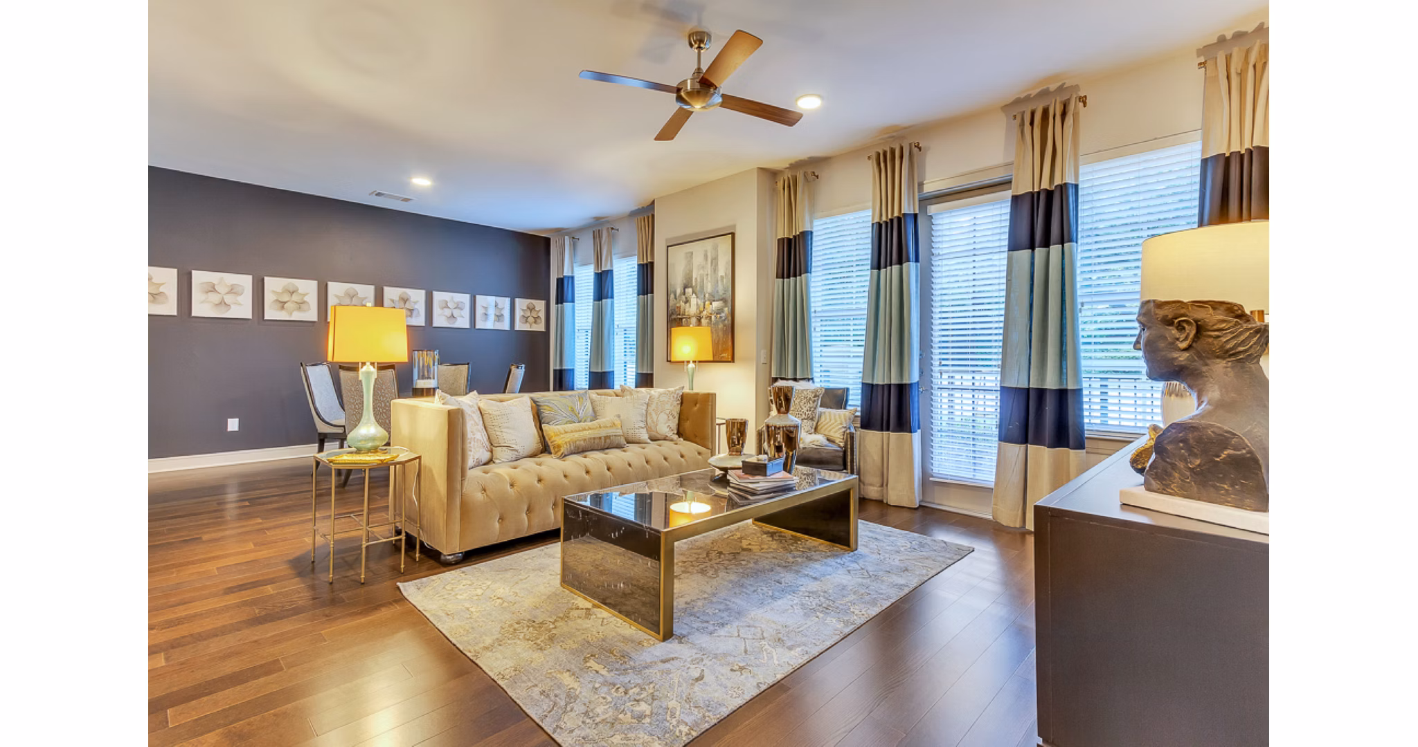 Elegant living room with modern decor at The Laurel Preston Hollow Apartments, featuring cozy seating and large windows for ample natural light