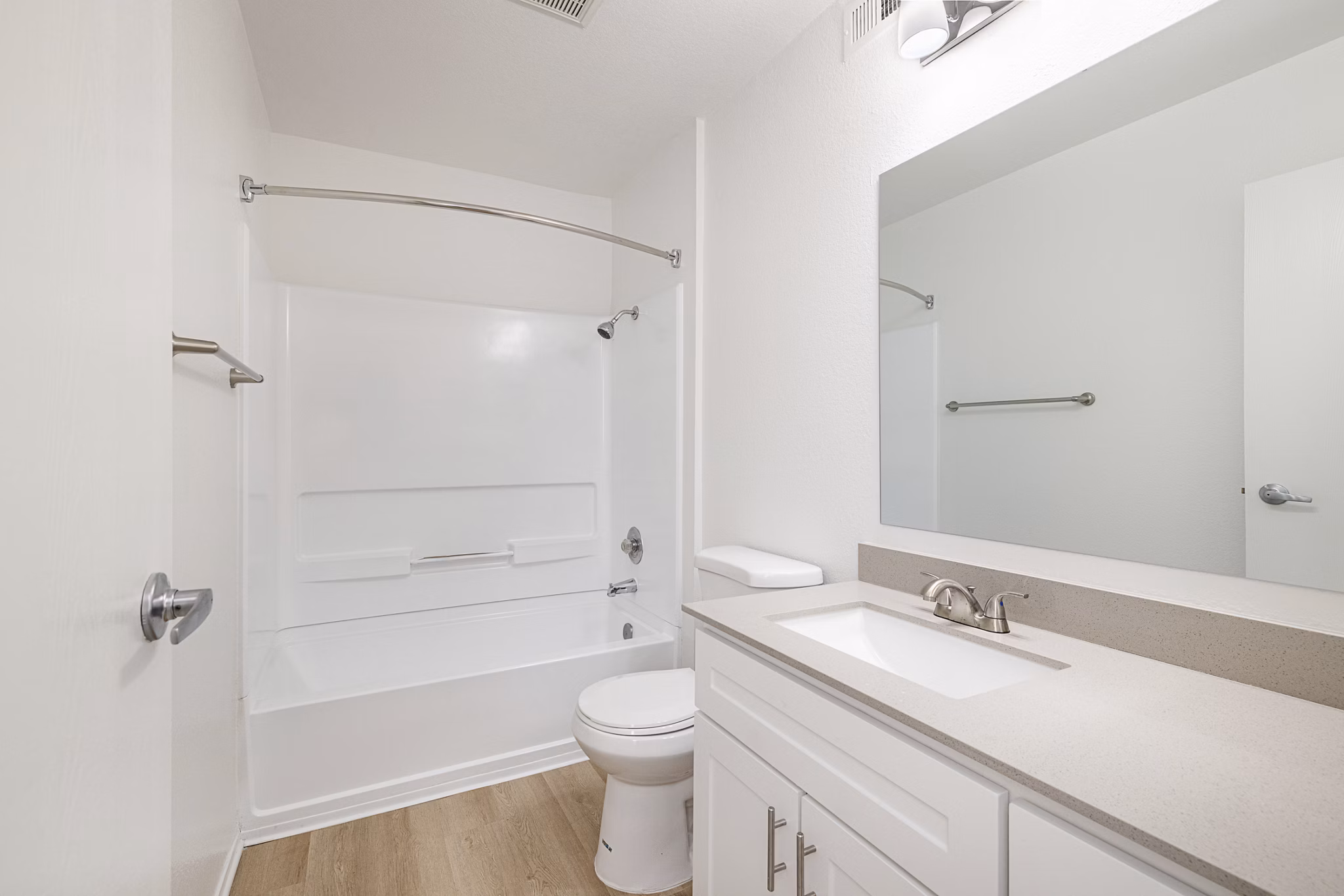 Bathroom featuring modern fixtures and marble countertop at The Landing Apartments