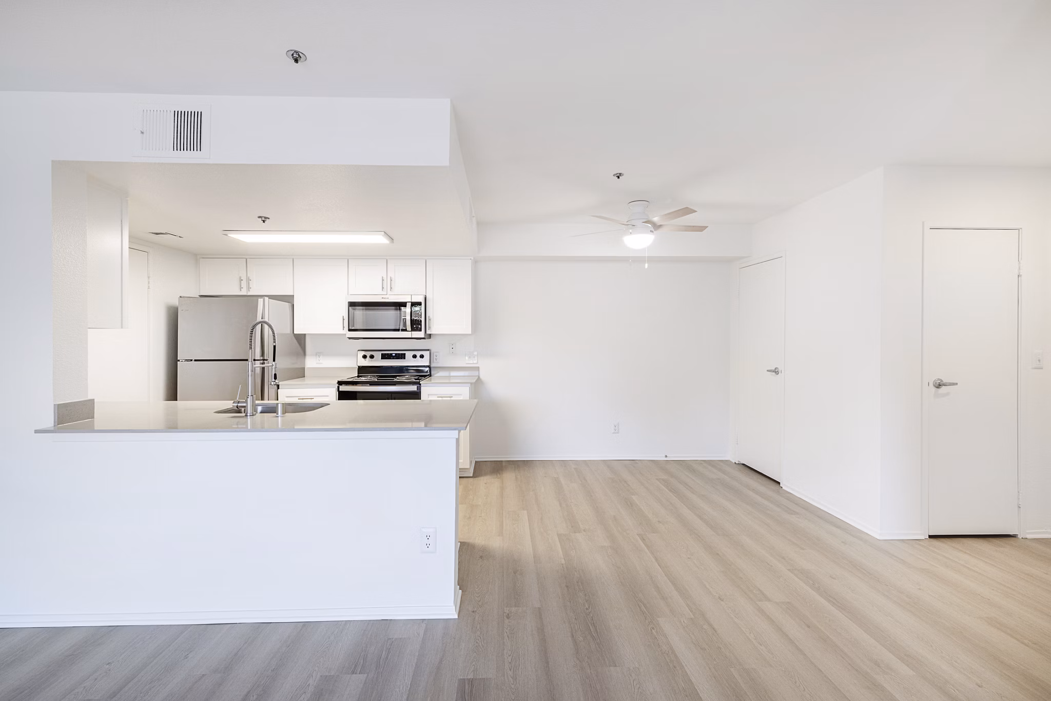 Sleek modern kitchen with stainless steel appliances at The Landing Apartments