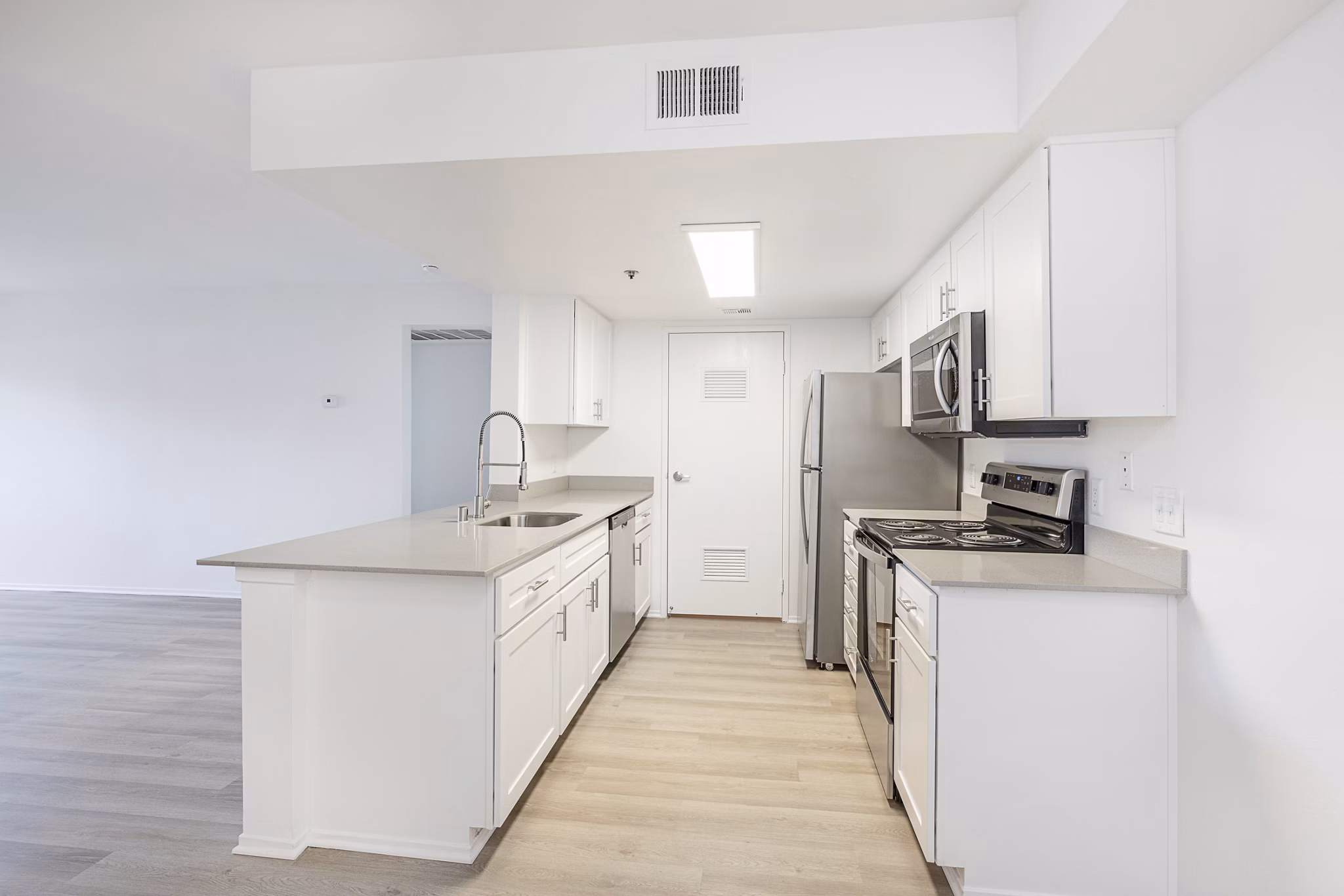 Kitchen featuring modern appliances and sleek cabinetry at The Landing Apartments