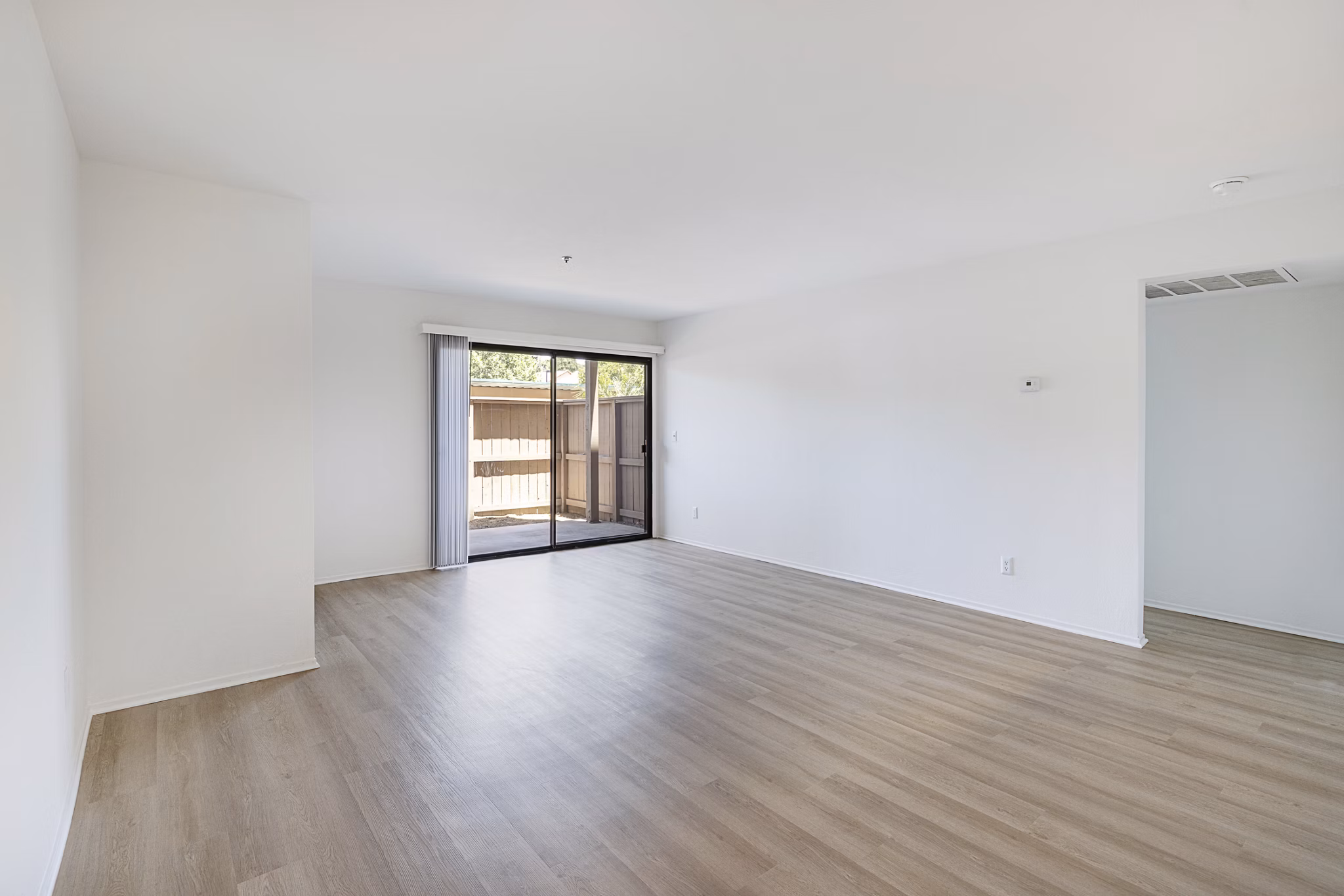 Spacious living room with modern decor and large windows at The Landing Apartments, offering luxury living in a vibrant community