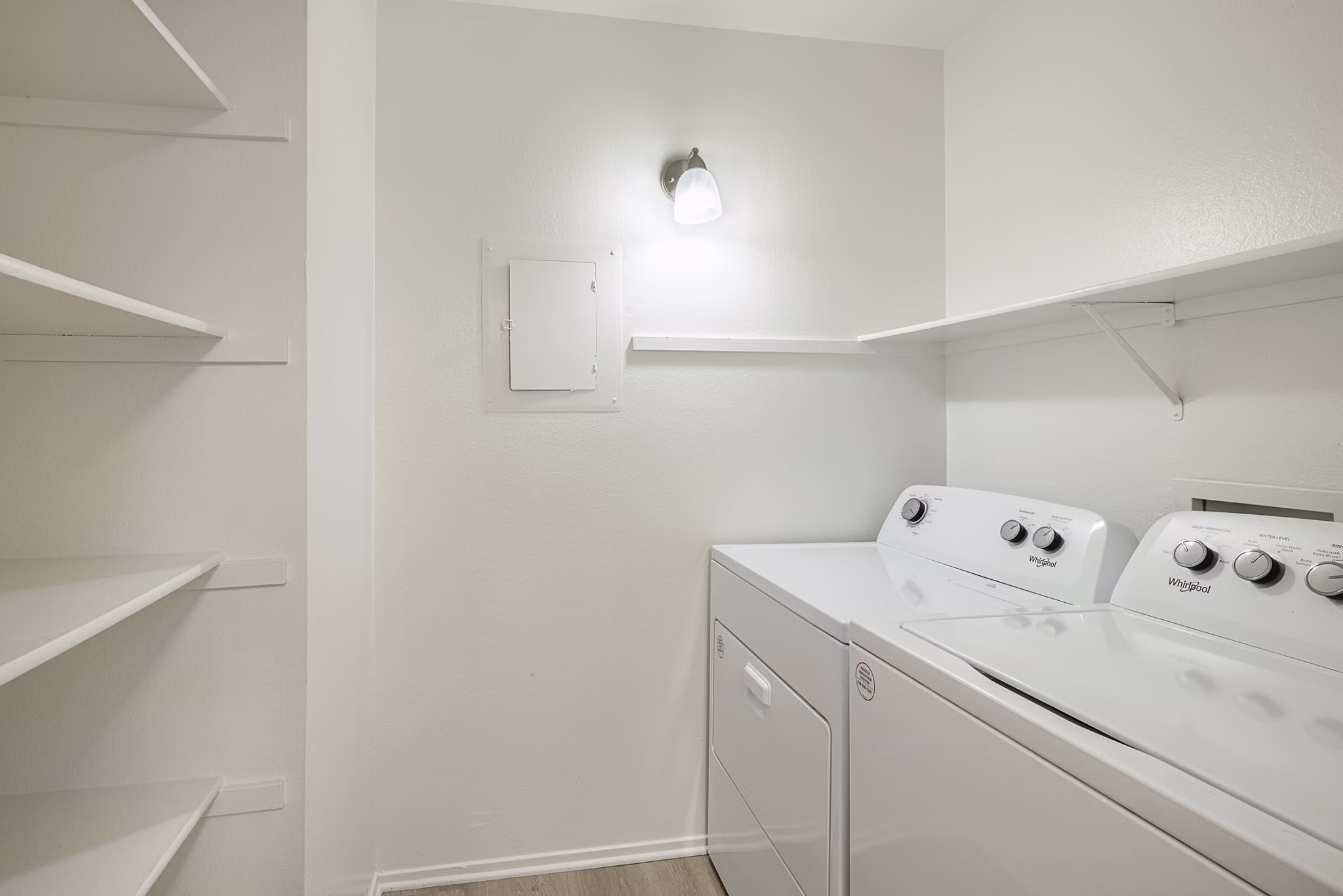 Laundry room with modern appliances at The Landing Apartments, a Greystar community