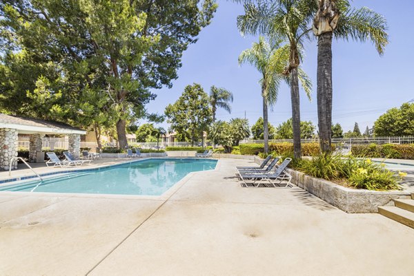 Outdoor pool with sundeck at The Landing Apartments, offering relaxed luxury living and amenities