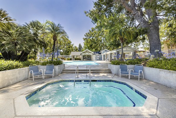 Hot tub with relaxing jets at The Landing Apartments, offering luxury amenities in a serene setting