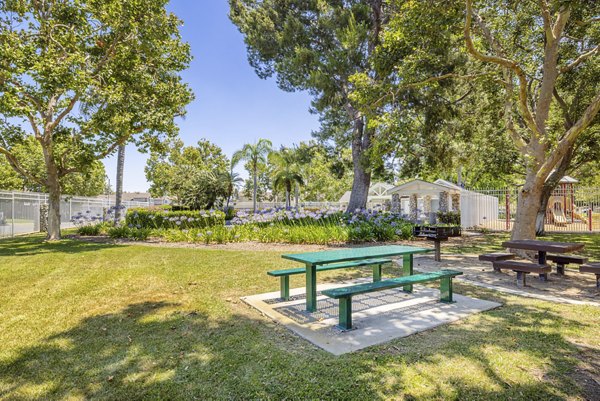 Courtyard featuring grill area and sport court at The Landing Apartments
