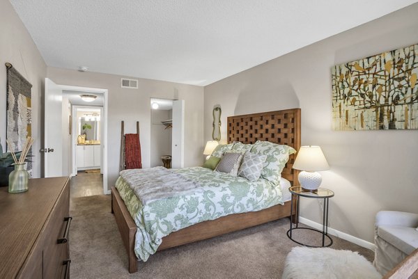 Bedroom featuring cozy dÃ©cor and a large window in Castilian Apartments