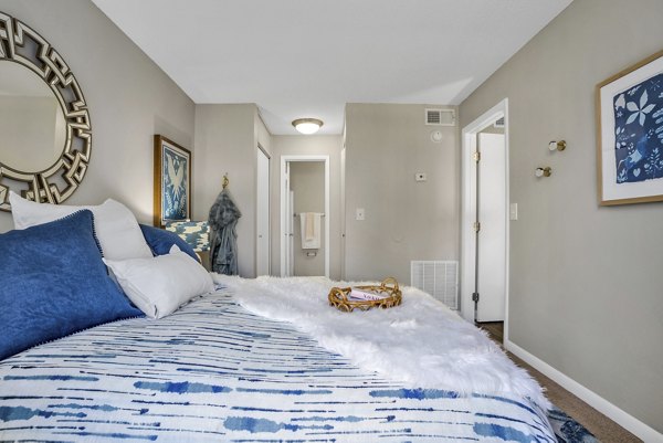 Bedroom with elegant furnishings and natural light at Castilian Apartments