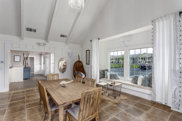 Stylish clubhouse featuring modern seating and entertainment area at Castilian Apartments