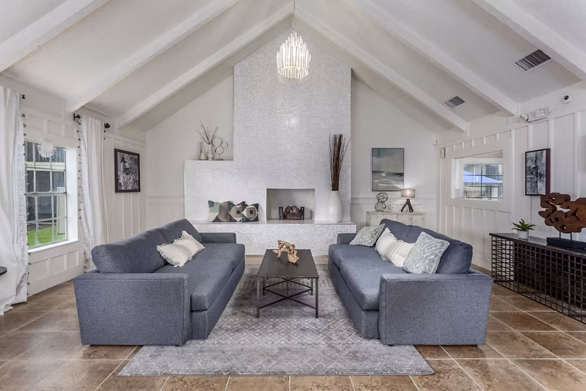 Modern clubhouse with cozy seating and entertainment area at Castilian Apartments