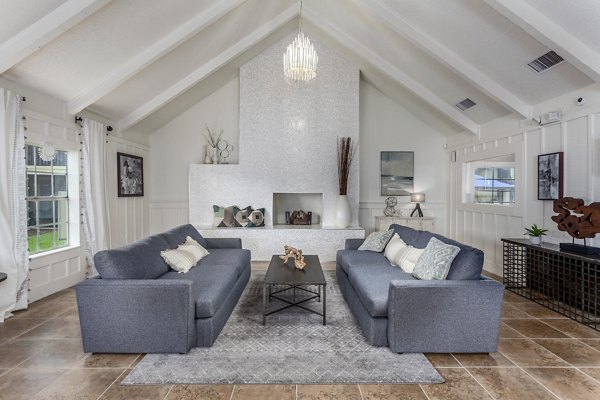 Modern clubhouse with cozy seating and entertainment area at Castilian Apartments
