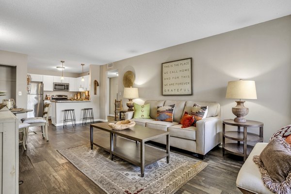 Spacious living room with modern decor at Castilian Apartments