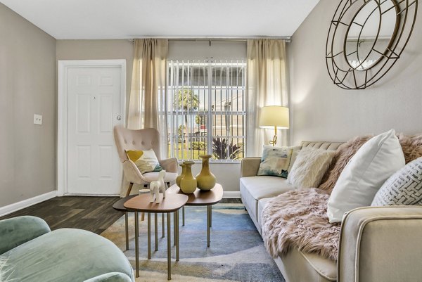 Modern living room with cozy seating and natural light at Castilian Apartments, luxury apartments by Greystar