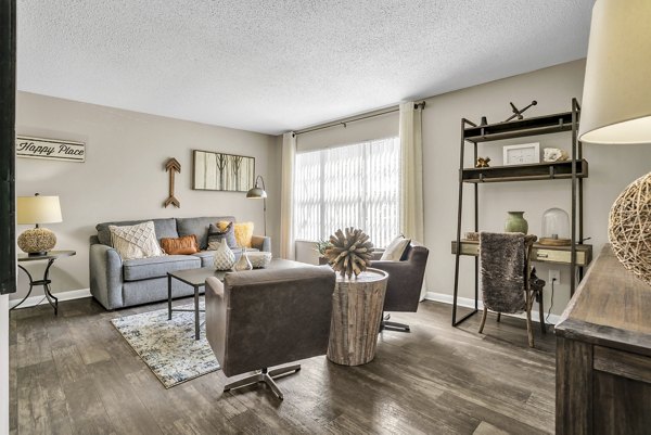 Spacious living room with modern furnishings in Castilian Apartments