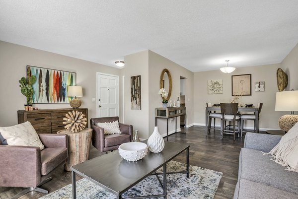 Spacious living room featuring modern furniture and natural light at Castilian Apartments in Greystar community