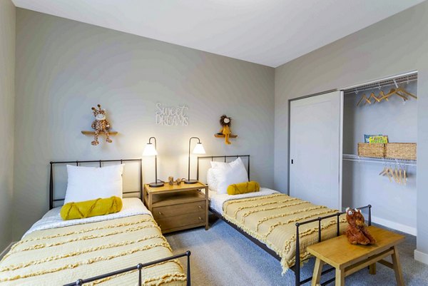 Cozy bedroom with neutral decor in Summerwell Maple Grove Apartments