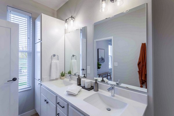 Modern bathroom with sleek fixtures and marble countertops at Summerwell Maple Grove Apartments