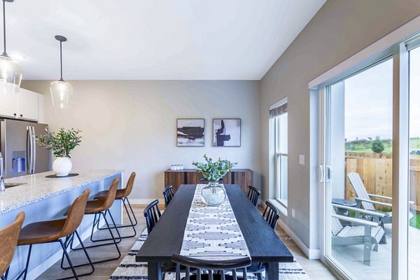 Dining room with elegant decor and modern lighting at Summerwell Maple Grove Apartments