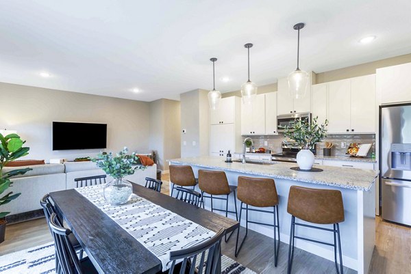 Dining area with elegant decor and large windows at Summerwell Maple Grove Apartments