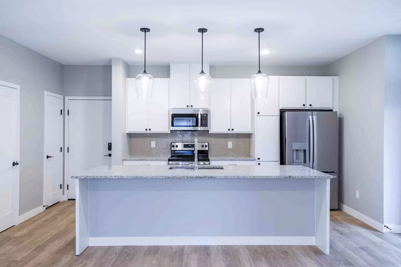 Modern kitchen with stainless steel appliances at Summerwell Maple Grove Townhouses