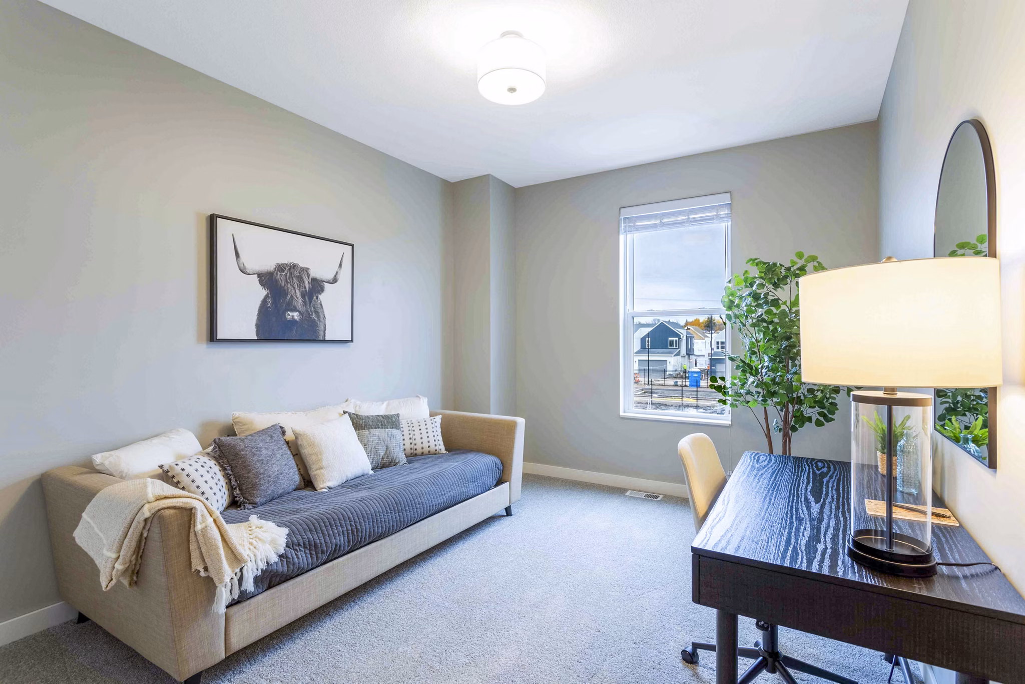 Home office with modern furniture and natural lighting in Summerwell Maple Grove Townhouses