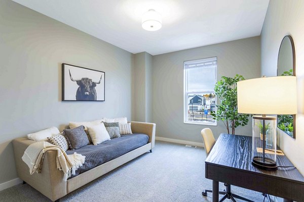 Home office with modern furniture and natural lighting in Summerwell Maple Grove Townhouses