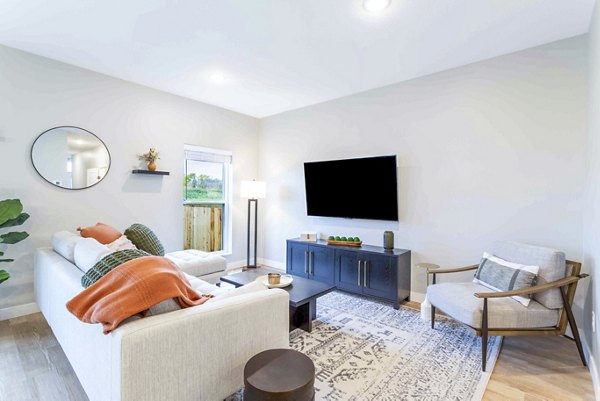 Living room with modern design and natural light at Summerwell Maple Grove Apartments