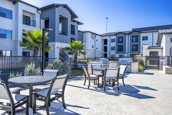 grill area/patio at Cascades at Onion Creek Apartments