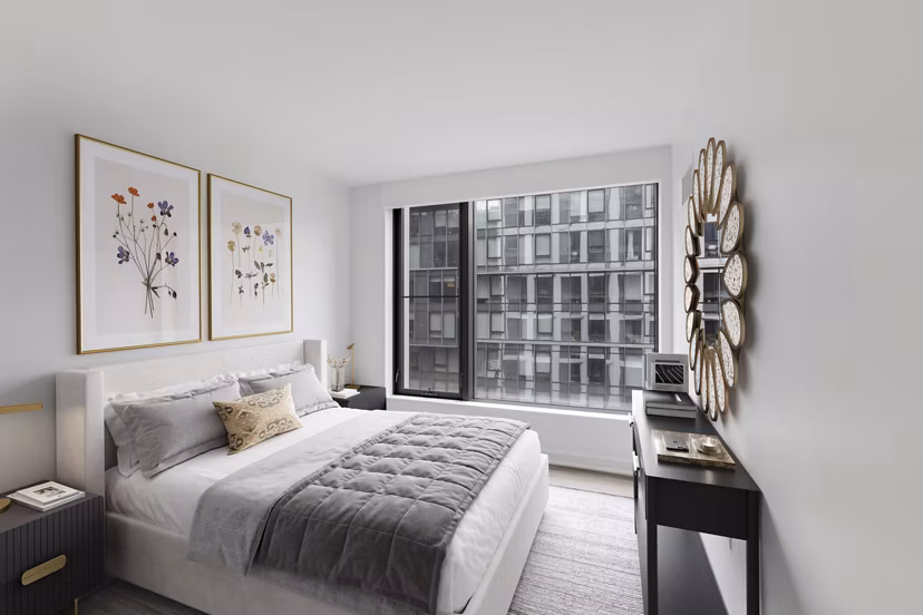 Bedroom with modern furnishings and ample natural light at Crossing DC Apartments, offering luxury urban living in Washington, DC