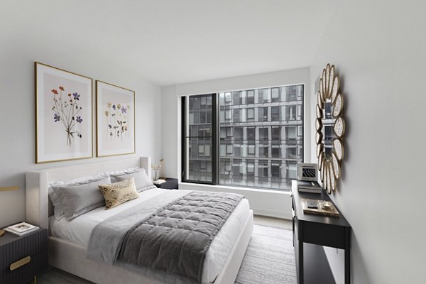Bedroom with modern furnishings and ample natural light at Crossing DC Apartments, offering luxury urban living in Washington, DC