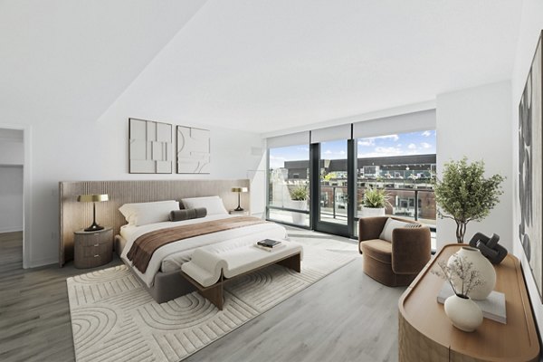Cozy bedroom featuring elegant decor at Crossing DC Apartments, a Greystar luxury community