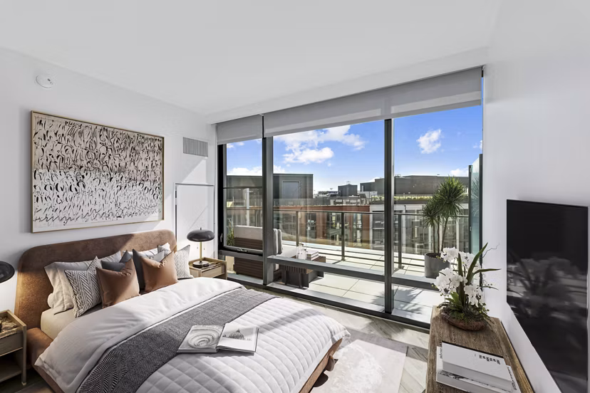 Elegant bedroom with modern decor at Crossing DC Apartments