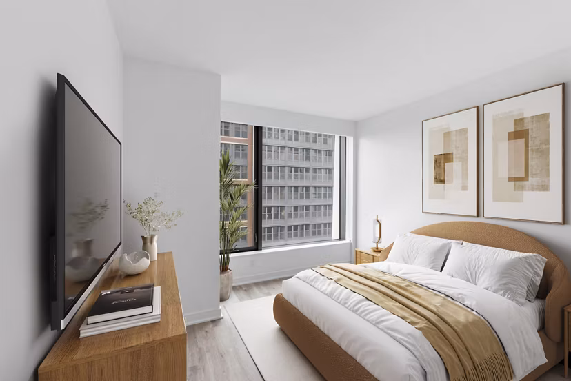 Bedroom with contemporary decor and ample natural light at Crossing DC Apartments, a Greystar luxury property in Washington, DC