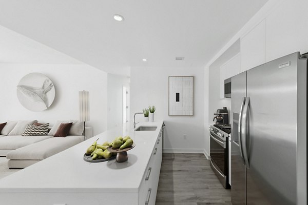Modern kitchen with stainless steel appliances in Crossing DC Apartments