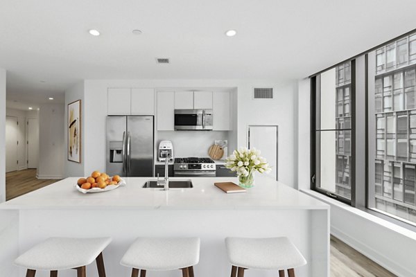 Modern kitchen with stainless steel appliances at Crossing DC Apartments