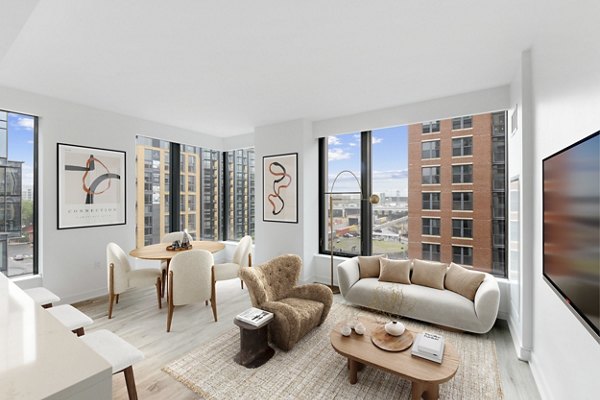 Cozy living room with modern decor at Crossing DC Apartments, featuring comfortable seating and stylish coffee table in vibrant Washington, DC