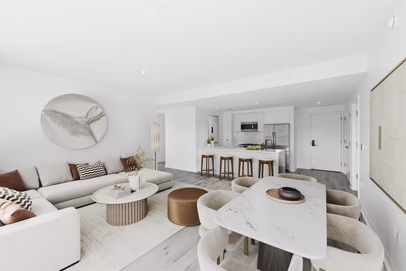 Spacious living room with modern decor at Crossing DC Apartments, featuring luxury seating and large windows