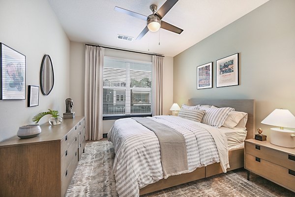 Cozy bedroom with elegant decor at Presidium Park Apartments featuring luxury bedding and soothing color palette